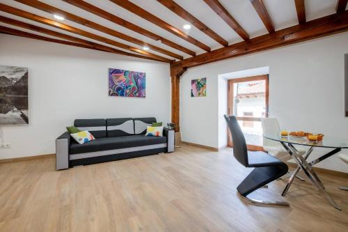 a living room with a couch and a table at Miravilla 25 Potes 1 in Potes