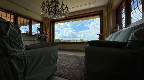 a living room with a window and two couches at Linda's Retreat in Fiano Romano