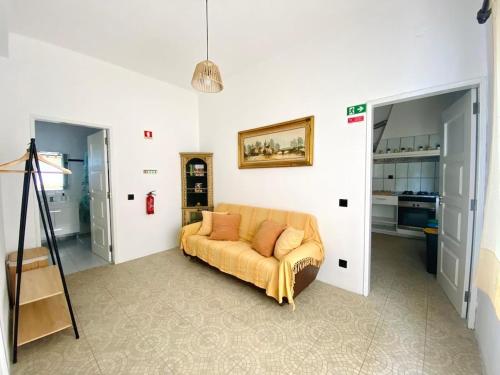 a living room with a couch in a room at Villa Rio in Praia do Ribatejo