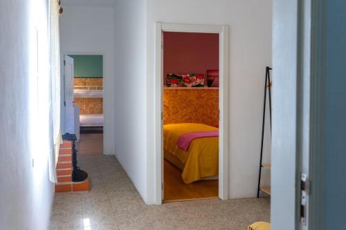 a bedroom with a bed in a white room at Villa Rio in Praia do Ribatejo