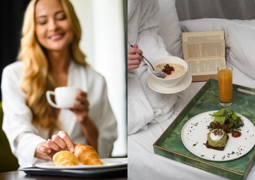 a woman sitting in a bed with a plate of food at POSESJA APARTAMENTY & SPA - Posesja Plażowa 4a I in Grzybowo