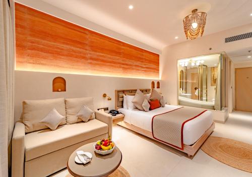 a hotel room with a bed and a couch at Sayaji Indore in Indore
