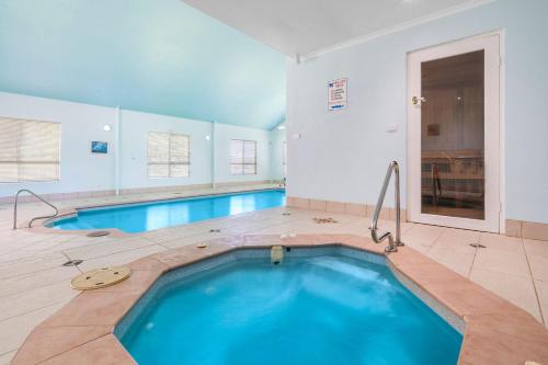 a large swimming pool with blue water in a room at Buffalo River Retreat - 5 Bedroom in Myrtleford