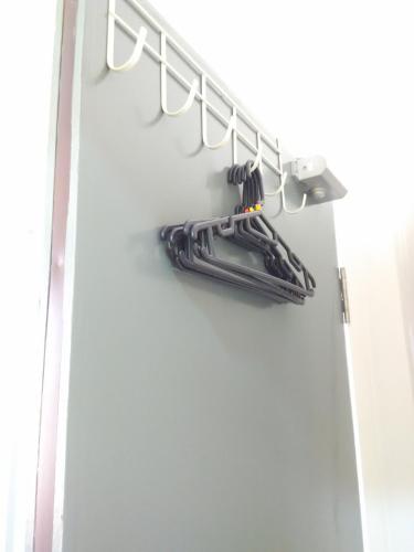 a group of umbrellas are hanging on a wall at Moon Eleven Hostel Near Klia & Klia2 in Sepang