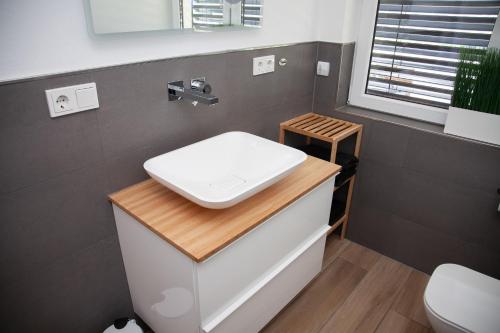 a bathroom with a toilet and a sink on a counter at WohnRaum Gäste- & Boardinghaus in Gusterath