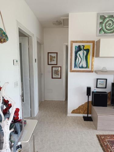 a living room with white walls and a painting on the wall at PM 15 Via Paolo Diacono in Buttrio