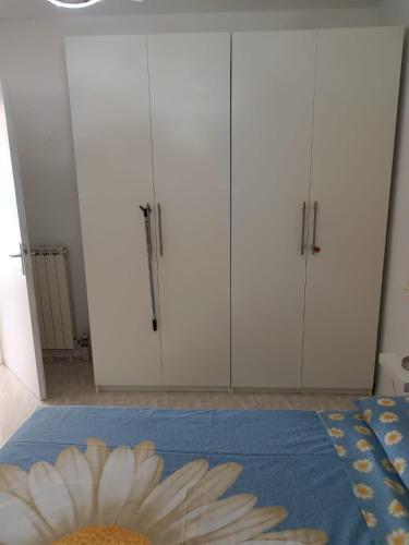 a room with white cabinets and a flower on a table at PM 15 Via Paolo Diacono in Buttrio