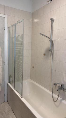 a bathroom with a shower and a bath tub at PM 15 Via Paolo Diacono in Buttrio