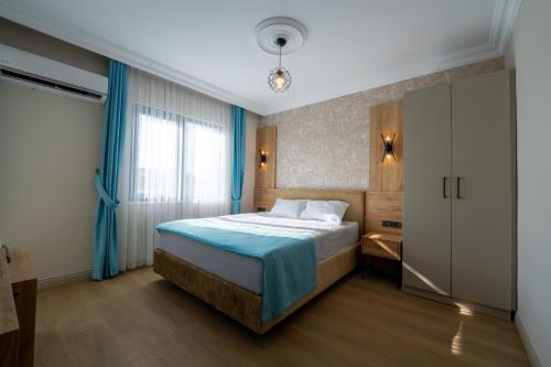a hotel room with a bed and a window at Coastline Orange Hotel in Antalya