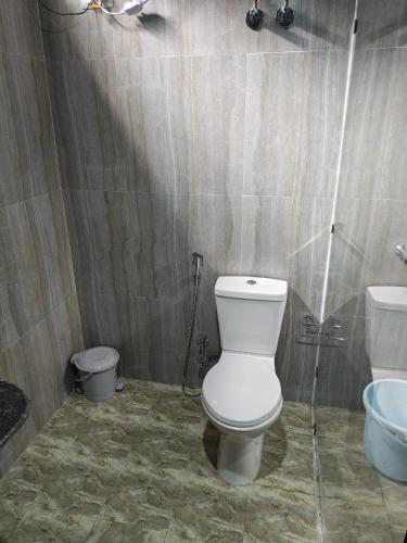 a bathroom with a toilet and a sink at Whispering Pine Villa in Lansdowne