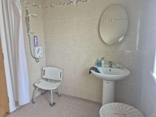 a bathroom with a sink and a mirror and a shower at Nora's Cottage Mullagh Kells - Sleeps 5 in Kells
