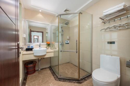 a bathroom with a shower and a toilet and a sink at 中英酒店佛山黄岐广佛新城店 in Foshan