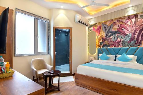 a bedroom with a king sized bed and a window at Hotel Saina International - Near Connaught Place & New Delhi Railway Station in New Delhi