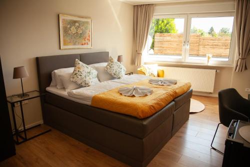 a bedroom with a large bed with a window at WohnRaum Gäste- & Boardinghaus in Gusterath