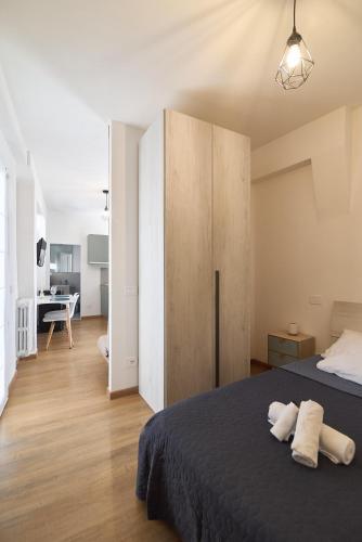 a bedroom with a bed and a large wooden cabinet at Casa Giglio in Perugia