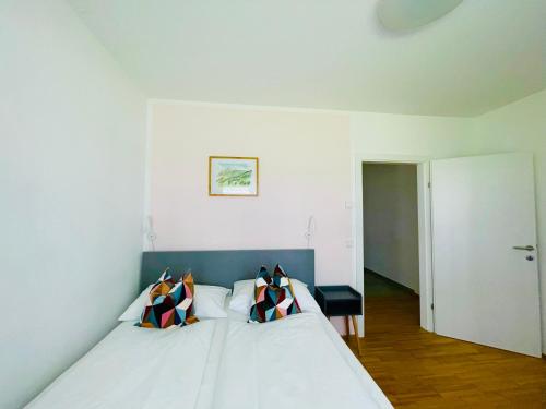 a bedroom with a bed with two pillows on it at APSTAY City Center I FREE Parking I Self Check-in in Graz
