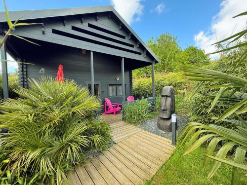 a house with a wooden deck in front of it at Gites d'Armor in Treguidel