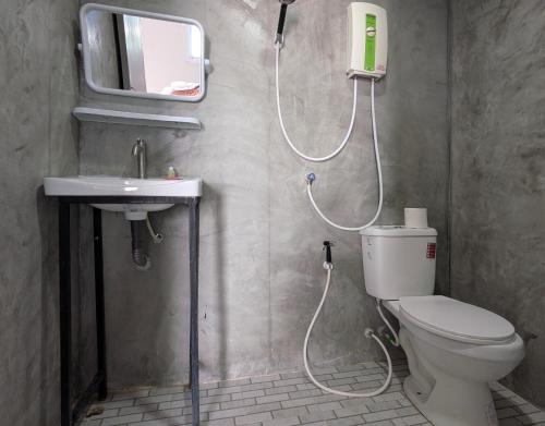 a bathroom with a shower and a toilet and a sink at Dreamy beachfront bungalow in Baan Tai