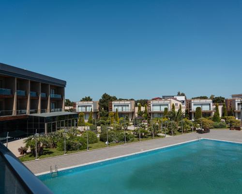 an empty swimming pool in front of a building at Shani Resort Hotel & Villas in Mardakan