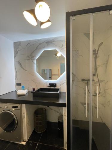 une salle de bain avec un lavabo et une machine à laver dans l'établissement Appartement T3 Mer Parking Conciergerie, à Bandol