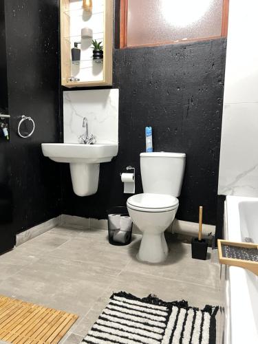 a bathroom with a toilet and a sink at Lumi's Nest in Johannesburg