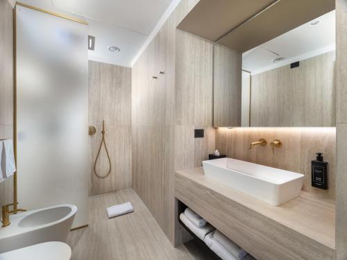 a bathroom with a sink and a mirror at The Glamore Milano Duomo in Milan