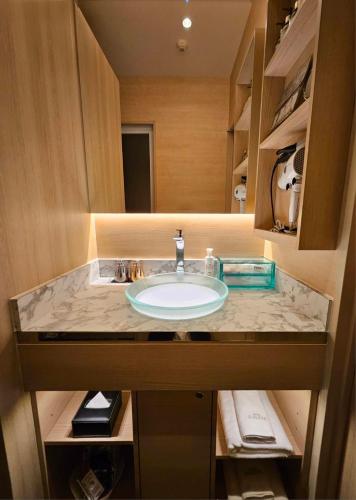 a bathroom counter with a sink in a room at Hotel Sulata Yamagata Airport in Higashine