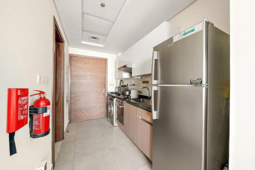 a kitchen with a stainless steel refrigerator at FIRST CLASS Studio Classy Comfort in Dubai
