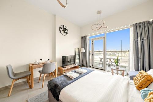 a bedroom with a bed and a desk and a window at FIRST CLASS Studio Classy Comfort in Dubai