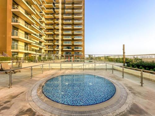 a swimming pool in front of a large building at FIRST CLASS Studio Classy Comfort in Dubai