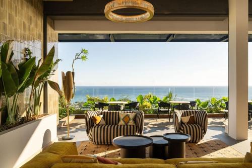 a living room with a view of the ocean at Legend Hill Resort and Spa in Rivière Noire