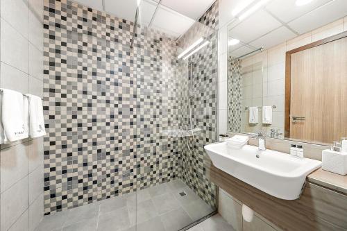 a bathroom with a sink and a shower at FIRST CLASS Studio Classy Comfort in Dubai