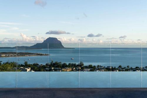 a view of a body of water with a mountain at Legend Hill Resort and Spa in Rivière Noire