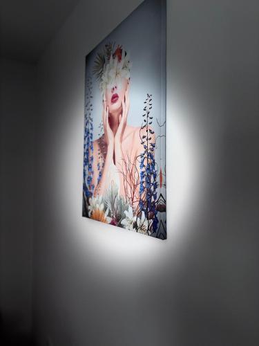 a painting of a woman on a wall at Apartman Sofija in Teslić