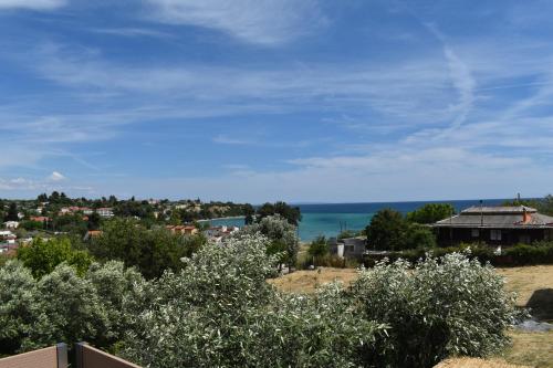 a view of a town and the ocean from a hill at Summer Project Theros in Nea Kalikratia