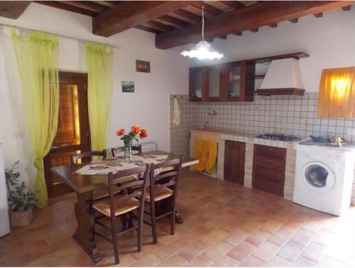 a kitchen with a table and chairs in a room at Agriturismo La Tana Del Lupo in Cantalupo