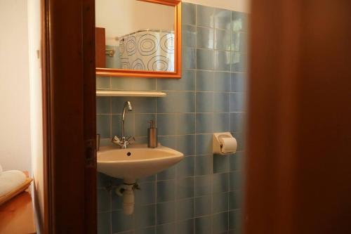 a bathroom with a sink and a mirror at Iris Rooms Trigona in Trygón