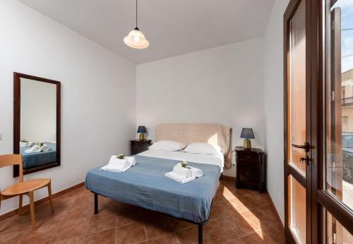 a bedroom with a bed and a mirror at SanVitoTour - Covo deI Pirati in San Vito lo Capo