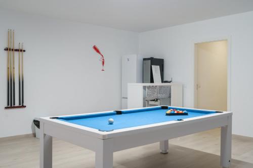 a billiard table in a living room with at Eden Villa, with jacuzzi and ocean view in Casal do Cigano