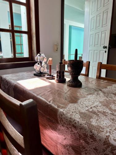 a dining room table with a table cloth and candles on it at Condomínio Taperapuan Praia Village in Porto Seguro
