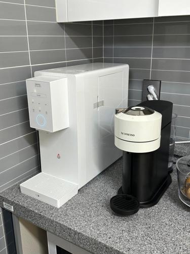 a coffee maker on a counter in a kitchen at A peaceful rest stop on your journey in Busan