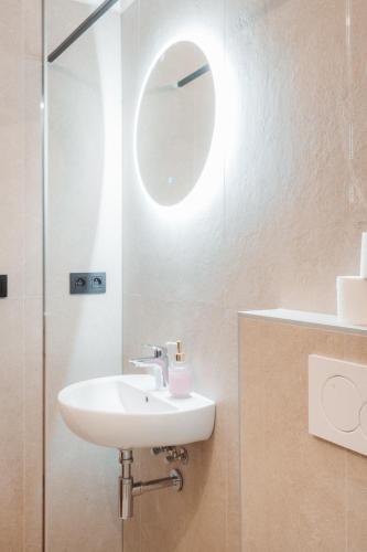 a bathroom with a sink and a mirror at Hviezdoslavova Apartments, Trnava Centre, Parking available in Trnava