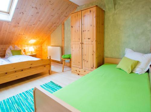 a bedroom with two beds and a wooden ceiling at Bergbauernhof Untermoos in Taxenbach