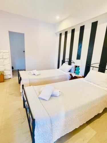 a room with three beds in a room at Villa Maria 1 in Paleokastritsa
