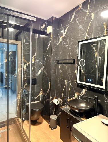 a bathroom with a glass shower and a sink at DK Luxury Living in Ioannina