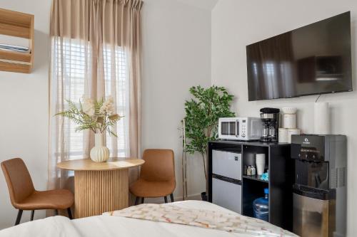 a bedroom with a bed and a table and chairs at Loft Style Studio In The Heart of D'Arts District in Houston