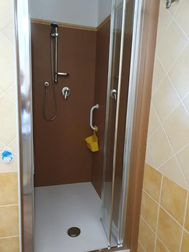 a shower with a glass door in a bathroom at Guido Holiday Home - Torre di Barì in Bari Sardo