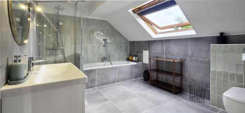a bathroom with a sink and a shower and a tub at Villa Garden - Disneyland Paris in Montévrain