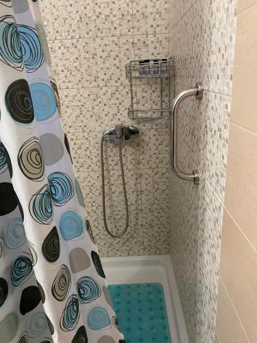 a shower with a shower curtain in a bathroom at Villa Marialena III in Kato Gatzea