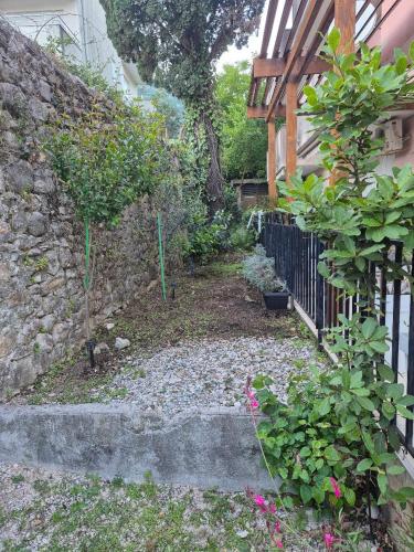 a garden next to a building with a fence at Masa in Baošići